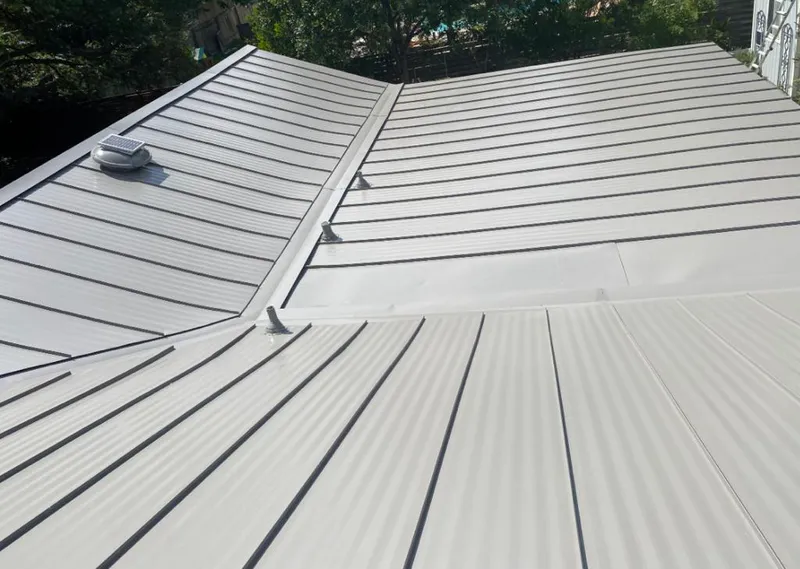 Solar attic fan installed on a metal roof for Roof Ventilation in Country Walk